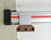 Parker OSP-P50 end cap detail showing black end block, carrier carriage, and rusty steel mounting bracket with three bolt holes