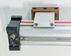 Parker OSP-P50 end detail showing pneumatic inlet port fitting, carriage assembly, and mounting hardware