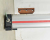 Parker OSP-P50 opposite end detail showing black end cap, green cushion adjustment screw, and steel mounting bracket
