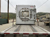 Nabertherm NR 1000/11 vacuum furnace rear end view on flatbed showing circular vacuum door with clamping ring and safety warning labels