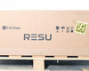 Long side of LG Chem RESU10H shipping box showing LG Chem and RESU branding printed on cardboard, with handling symbols and a QR code sticker