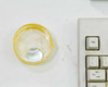 Close-up of yellow plastic lens/mirror holder accessory from Labsphere RSA-HP-8453 system, next to keyboard