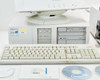 HP Vectra XM 5/120 Series 4 desktop computer with Compaq KB-3923 keyboard, two Labsphere CDs, and accessories on table; cracked casing visible on computer side panel