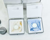 Two Labsphere certified reflectance standard boxes open showing white diffuse reflectance disk standards in protective packaging; Labsphere SRS-99-010 canister visible at left