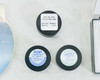 Three Labsphere calibration standard puck holders — SRS-99-010 AS-01160-060 Serial BR21A-1224 (top), two additional Labsphere SRS-99-010 pucks with date and calibration labels (bottom)