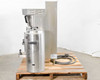 Fetco CBS-61H coffee brewer side profile on pallet with one Luxus dispenser and power/water hose visible