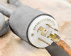 Fetco CBS-61H power cord twist-lock plug close-up showing 30A 600V 4C 30A 250V rating markings