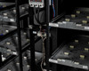 Interior detail of Eaton 9390 battery cabinet showing battery tray shelves, interconnect wiring, and monitoring device