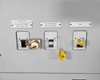 Transfer switch front panel showing three breakers labeled: UPS Main Output Breaker, UPS Output Breaker 1, and Spare