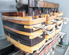Powersmiths K-Star transformer – detailed view of transformer coil stacks showing laminated core sections and copper windings with insulation tape