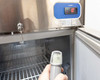 LabRepCo LABLD-25-SDSS lab refrigerator door open with digital controller set to 1°C and external laser infrared thermometer measuring interior temperature at approximately 4°C