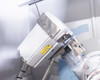 Close-up of X-ray detector module with radiation warning label mounted on goniometer arm