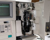 Nova Biomedical BioProfile 100 Plus – front door open during power-on showing CRT screen with 02-Jan-2024 timestamp, sensor module array, and internal cabling