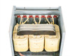 T3045K0034B transformer interior showing three wound coil cores and laminated core stack from above with panel removed