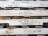 Close-up of pallet deck boards with stenciled markings reading 48x48 and other stamp codes visible