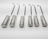 All 6 dipping canisters laid out — 4 with perforated drain-hole ends and 2 with solid ends, with color-coded ID tabs