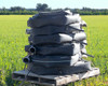 Stack of Toro Blueline oval polyethylene drip hose sections on a pallet showing coiled hose and coupler ends