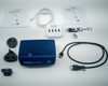 Zeiss Axiocam 202 mono camera with full accessory kit laid out: 2 software discs, USB 3.0 hub, USB stick, power cable, interchangeable power adapter plugs, microscope interface cable, and camera body
