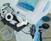 Lumenis NuEra Tight handset tray close-up showing face handset, bipolar handset, RF heads, and grounding pad