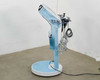 Lumenis NuEra Tight side profile view showing cart arm, blue chassis column, and circular base on right side