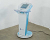 Lumenis NuEra Tight APMD130 full unit front view on round wheeled base with handpiece holder arms