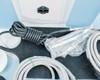 Lumenis NuEra Tight handset compartment close-up with one handset in plastic sleeve and additional cable sets