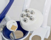 Close-up of Pollogen Legend+ SMD Applicator VO with gold matrix tip insert and round multi-electrode applicator head resting in holder