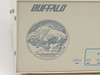 Buffalo Printer Buffer SL – close-up of front panel Buffalo logo and nickel coin emblem with STATUS and channel indicator strip