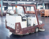 PowerBoss TSS/90-HD-HC left rear three-quarter view showing full machine profile, ROPS overhead guard, propane tank, and rear brush