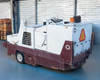 PowerBoss TSS/80-HD — right rear three-quarter view showing operator cab, orange beacon light, side panels, and rear body