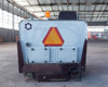 PowerBoss TSS/80-HD — rear view showing slow-moving vehicle triangle reflector, PowerBoss logo, AAR Brooks & Perkins badge, and rear body panels