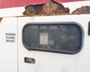 Terex T120 generator access door with inspection window, Check Fluid Daily placard, and surface rust visible along top edge of enclosure