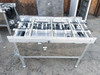 Short Excel Flow SC23460 conveyor section with compact roller bed and motorized drive components visible – front angle