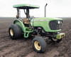 2005 John Deere 5425 65 HP 2WD diesel tractor — 3/4 front view showing open canopy, turf tires, and green hood in field setting