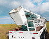 Hi-Ranger 6TD65PB1 boom turret and single-person bucket close-up – bucket partially raised showing articulation joint and wear
