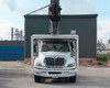 2012 International 4400 Durastar bucket truck front view – International grille badge, cab guard, and vertical boom visible