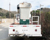 2012 International bucket truck rear view – pintle hitch, tail lights, diamond-plate bumper, and bucket stowed overhead