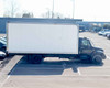 International 4300 DuraStar 20 ft refrigerated box truck – passenger-side full profile view showing white box body and black cab in parking lot