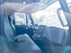 Interior cab view of 2014 International 4300 DuraStar – bench seating, automatic transmission, and center console from passenger side