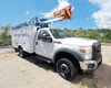 2013 Ford F550 bucket truck driver-side view with Altec AT37G boom fully raised, showing orange bucket platform at height