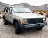 1995 Jeep Cherokee XJ – three-quarter front view from driver side showing hood and fender condition