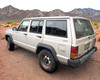 1995 Jeep Cherokee XJ – rear three-quarter view from passenger side showing overall body and wheels