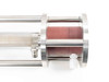 Ametek 3482-MAC5115 screw pump assembly – closeup of outlet end flange showing hose fittings, clear acrylic pump body section, and stainless steel flanges