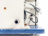 Visumatic S-18 power cord exit detail and rear corner of control enclosure showing surface rust and corrosion on blue base plate