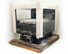 Veeco OSP Overhead Scanning Profiler – three-quarter front-left view showing white gantry enclosure, scan stage, and electronics chassis on wooden pallet