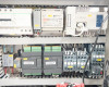 Interior lower electrical panel of Lneya SUNDI-255 showing Mean Well DIN-rail power supply, LNEYA PLC/controller, and multiple relay/contactor assemblies