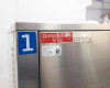 Close-up of Sundi-1A15 upper cabinet corner showing Duratherm G-LV heat transfer fluid label, LNEYA branding tag, and factory specification sticker