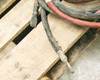 Output cable ends showing battery connectors — one with pink insulation, one bare — on pallet