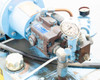 Top-mounted pump and valve block assembly with pressure gauge, copper tubing, and fittings — moderate surface rust on pump body