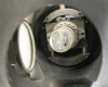 Interior view of lamp housing looking into rear barrel showing internal bulb on adjustable mount bracket and elliptical reflector